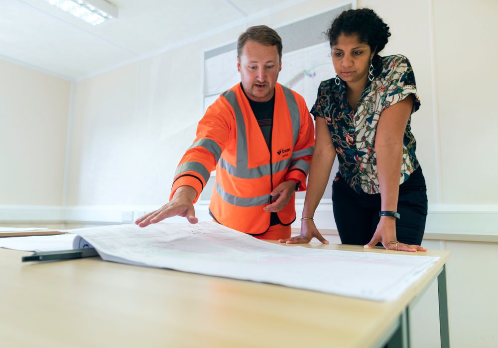 Engineers reviewing a blueprint together