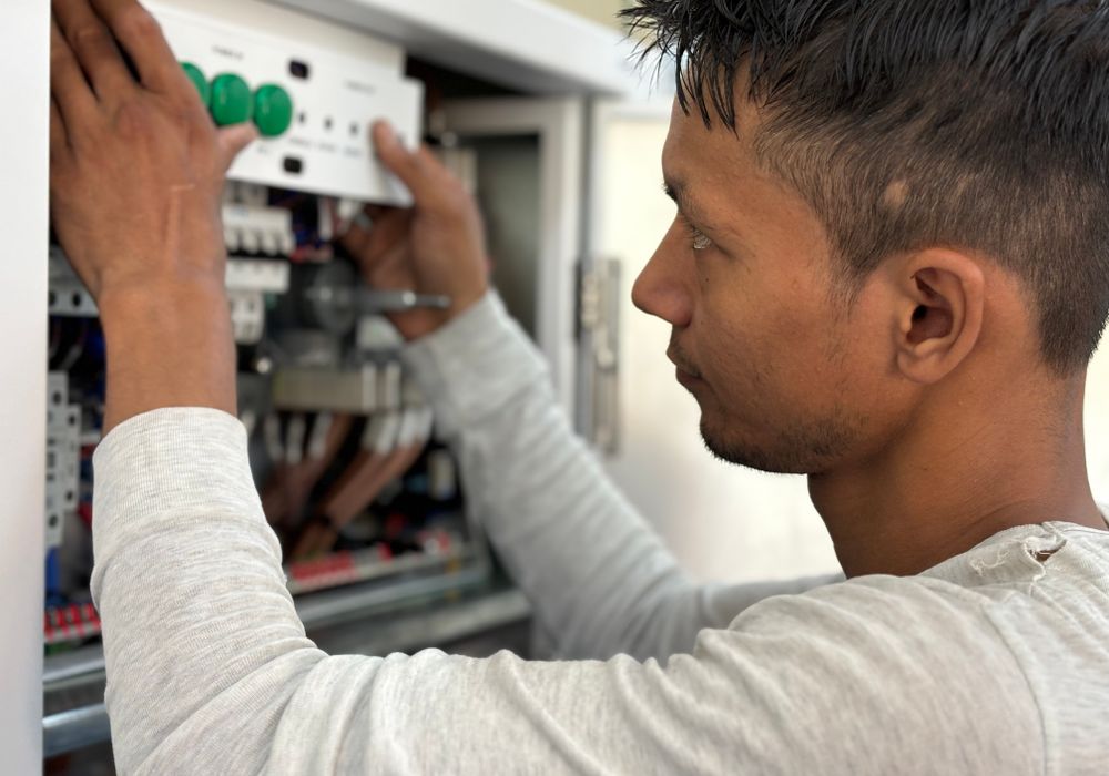 Electrician inspecting a control panel